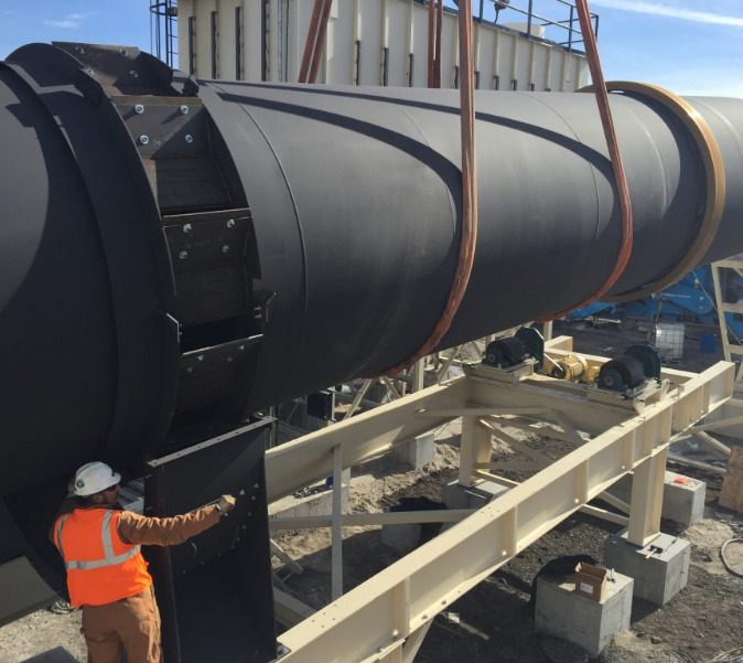 Construction workers place Ti281 Delivery Rotary Drum Mixer into the ground